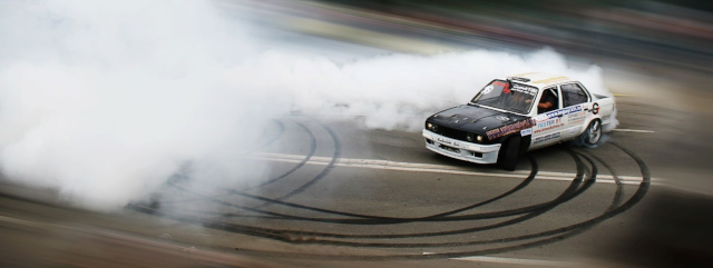 image of teen driver doing a doughnut in a cloud of smoke