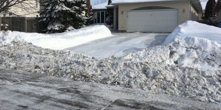end of driveway plowed in with snow