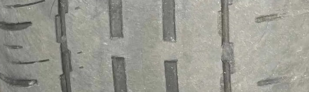 Image of wear bars showing tread depth of a worn out tire