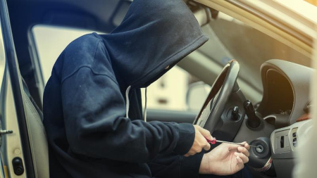 Image of a thief at work adding to the list of stolen vehicles