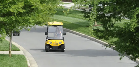 golf cart being driven on the road