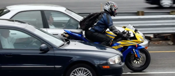 image of motorcycle in a race between cars