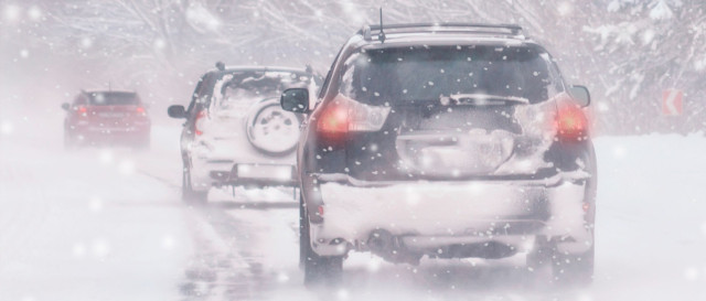 image of traffic in snowy weather to illustrate due care