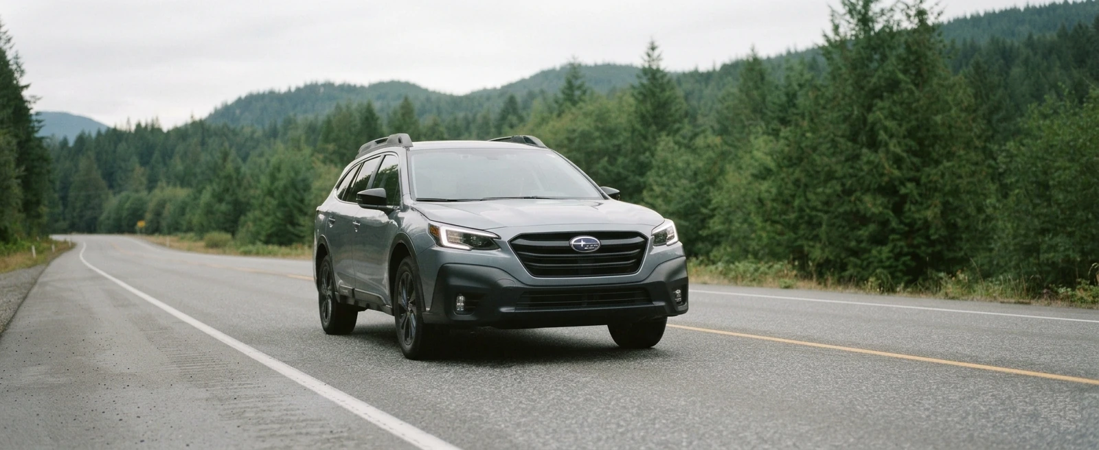 Gray car with daytime running lights illuminated on a British Columbia highway