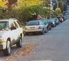 image of vehicles parking on shoulder of the road